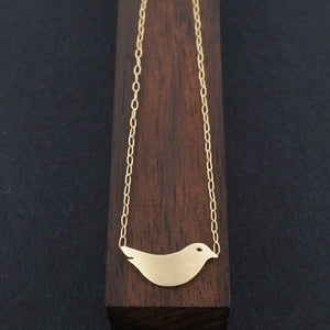 ミニマリストの鳥のネックレス、純金または銀 - チェーンに取り付けられています